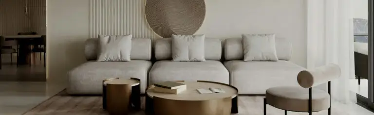 Neutrale woonkamer met beige bank, ronde tafels en rustige, moderne stijl.