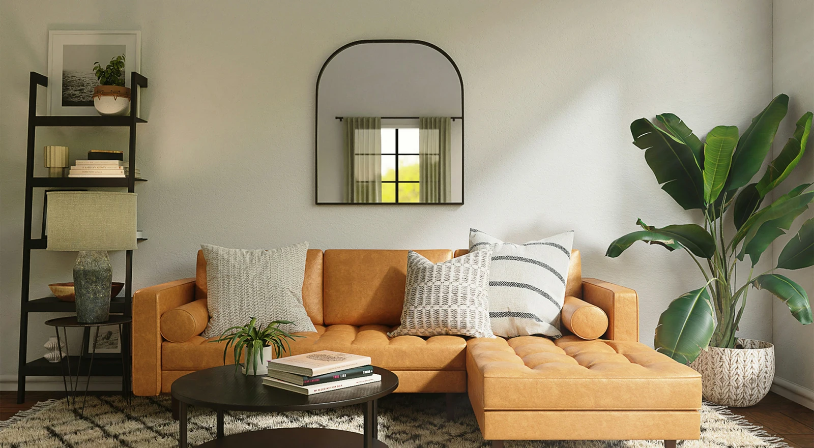 moderne-design-meubels-woonkamer Moderne woonkamer met cognackleurige leren bank, ronde salontafel, spiegel en grote kamerplant.